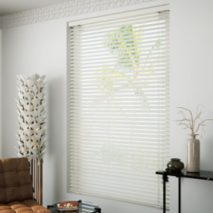 Living room with white blinds and brown couch, illuminated by natural light. Aluminum Venetian Blinds.