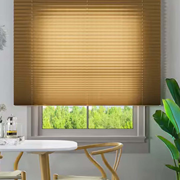 A window with pleated blinds and a table in front of it.