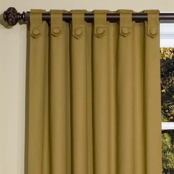 Elegant curtain in brown and gold with reversed rod loop.