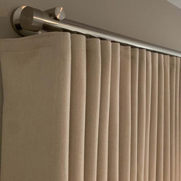 Beige curtain hanging from Easy Wave Curtains rod.