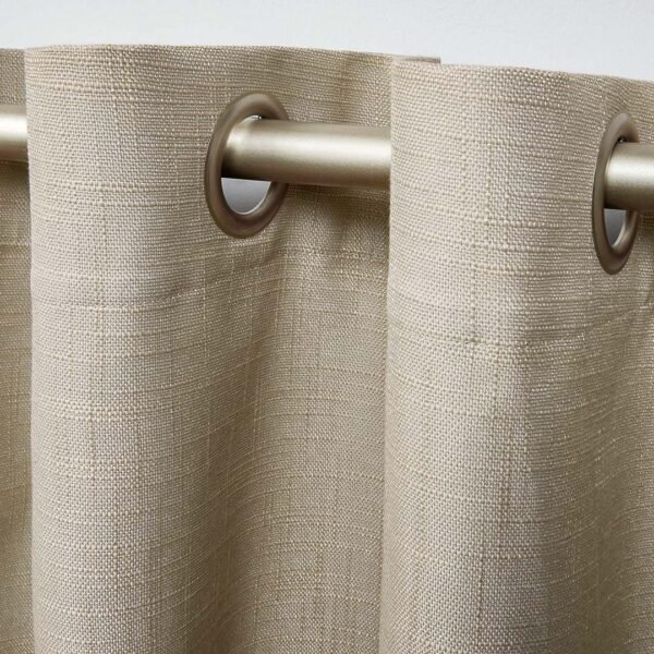 Close-up of grommet/eyelet curtains with two metal rings.