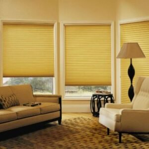 A living room with honeycomb blinds and a yellow couch.